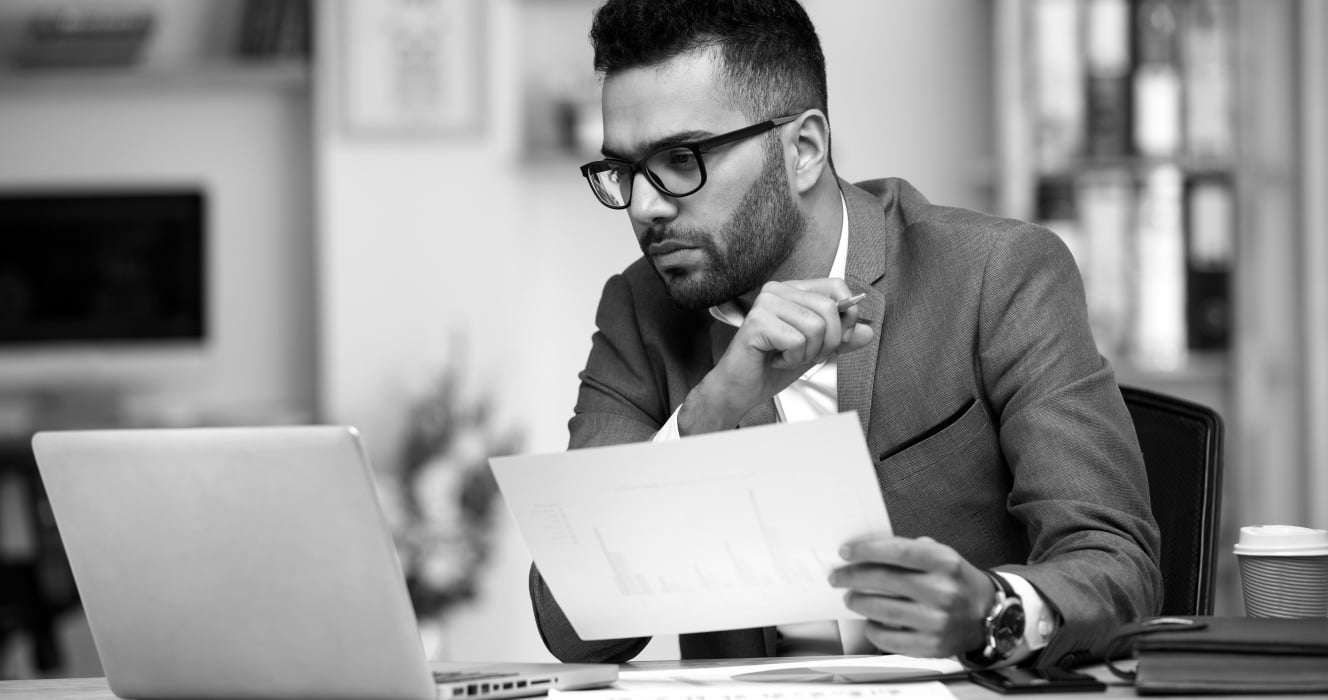 An associate looking at financials on his computer